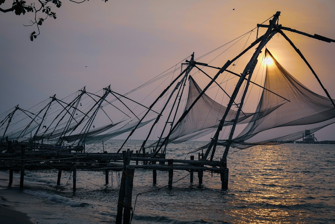 Chinese fishing nets along the Kochi waterfront at sunset